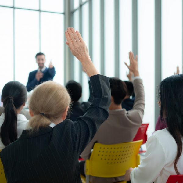 A group of business people organizes a seminar. Discuss the success of doing business